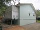 Exterior view showcasing the side of the house and covered patio area at 5949 Se 164Th Ct, Ocklawaha, FL 32179