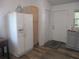 Functional kitchen featuring a large refrigerator, pantry and access to the backyard at 5949 Se 164Th Ct, Ocklawaha, FL 32179