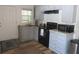 Galley style kitchen with granite countertops, black appliances, and new sink at 5949 Se 164Th Ct, Ocklawaha, FL 32179