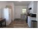 Well-lit kitchen with updated grey cabinets, granite countertops, and wood-look flooring at 5949 Se 164Th Ct, Ocklawaha, FL 32179