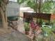 Outdoor patio features a swing, bench, and plants adjacent to the house and a detached garage at 5949 Se 164Th Ct, Ocklawaha, FL 32179