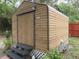 The exterior of the shed is wood and has a side door for access at 5949 Se 164Th Ct, Ocklawaha, FL 32179