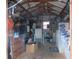View of interior storage area featuring a rocking chair, shelves, tools and equipment at 5949 Se 164Th Ct, Ocklawaha, FL 32179