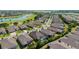 A scenic aerial view of a community with a golf course and pond at 6394 Sw 97Th Terrace Rd, Ocala, FL 34481