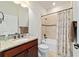 Nicely appointed bathroom showcasing granite countertops, dark wood vanity, and shower-tub at 6394 Sw 97Th Terrace Rd, Ocala, FL 34481