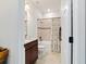 Well-lit bathroom featuring a vanity, toilet, and shower-tub combination with neutral tile at 6394 Sw 97Th Terrace Rd, Ocala, FL 34481