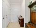 Hallway with tile flooring, coat rack, and neutral-toned walls at 6394 Sw 97Th Terrace Rd, Ocala, FL 34481