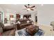 Inviting living room and kitchen area featuring an open layout, ceiling fan, and comfortable furniture at 6394 Sw 97Th Terrace Rd, Ocala, FL 34481