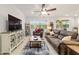 Cozy living room with tile flooring, ceiling fan, decorative rug, and comfortable furniture at 6394 Sw 97Th Terrace Rd, Ocala, FL 34481