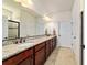 Main bathroom featuring double sinks, granite counters, cherry wood cabinets, and a separate shower at 6394 Sw 97Th Terrace Rd, Ocala, FL 34481