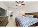 Bedroom with a tray ceiling, ceiling fan and ensuite bathroom at 6394 Sw 97Th Terrace Rd, Ocala, FL 34481