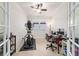 Bright office space featuring an exercise machine, ceiling fan and a functional workspace at 6394 Sw 97Th Terrace Rd, Ocala, FL 34481