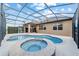 Inviting screened-in pool and spa with a covered patio area for outdoor enjoyment at 6394 Sw 97Th Terrace Rd, Ocala, FL 34481