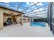 Beautiful screened-in pool and patio area with lush landscaping, providing a private retreat at 6394 Sw 97Th Terrace Rd, Ocala, FL 34481