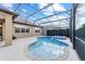 Sparkling pool and spa within a screened enclosure, offering a tranquil and private outdoor space at 6394 Sw 97Th Terrace Rd, Ocala, FL 34481