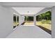Covered back porch with concrete flooring overlooking a beautiful wooded backyard at 6689 Nw 61St St, Ocala, FL 34482