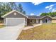Charming single-story home featuring a neutral exterior and a two-car garage at 6689 Nw 61St St, Ocala, FL 34482