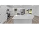 Modern kitchen with white cabinets, stainless steel appliances, and quartz countertops at 6689 Nw 61St St, Ocala, FL 34482