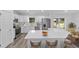 Modern kitchen with stainless steel appliances, white cabinets, and quartz countertops at 6689 Nw 61St St, Ocala, FL 34482