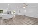 Open-concept living room features vaulted ceilings, sleek flooring and modern ceiling fan at 6689 Nw 61St St, Ocala, FL 34482