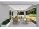 Inviting covered patio with comfortable seating and a view of the wooded backyard at 6689 Nw 61St St, Ocala, FL 34482