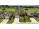 Aerial view of a home with a well-manicured lawn surrounded by lush greenery in a beautiful community at 6868 Sw 95Th Cir, Ocala, FL 34481