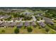 Community aerial view featuring lush landscaping, peaceful lake, and well-maintained homes at 6868 Sw 95Th Cir, Ocala, FL 34481