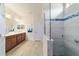 Open bathroom showcases a spacious double vanity and large shower with sleek gray tile at 6868 Sw 95Th Cir, Ocala, FL 34481