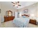Warm bedroom featuring neutral colors, wood furniture, and cozy decor at 6868 Sw 95Th Cir, Ocala, FL 34481