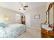 Cozy bedroom featuring plush carpet, shuttered windows, and ample natural light at 6868 Sw 95Th Cir, Ocala, FL 34481