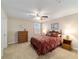 Comfortable bedroom features a ceiling fan and shuttered windows at 6868 Sw 95Th Cir, Ocala, FL 34481
