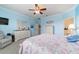 Serene bedroom retreat features carpeted floors, ceiling fan, and light blue walls for a tranquil atmosphere at 6868 Sw 95Th Cir, Ocala, FL 34481