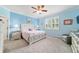Cozy bedroom with bright-blue walls, ceiling fan, and carpeted floor at 6868 Sw 95Th Cir, Ocala, FL 34481