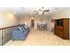 Open upstairs bonus room with a ceiling fan and seating at 6868 Sw 95Th Cir, Ocala, FL 34481