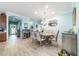 Elegant dining room with classic chandelier and hardwood floors, perfect for Gathering gatherings and entertaining at 6868 Sw 95Th Cir, Ocala, FL 34481