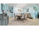 Dining room with beautiful chandelier, table with seating for six, and bright natural lighting at 6868 Sw 95Th Cir, Ocala, FL 34481