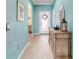 Bright foyer with light blue walls and a decorative table that leads into other rooms of the home at 6868 Sw 95Th Cir, Ocala, FL 34481