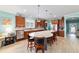 Bright kitchen with stainless appliances, hardwood floors, and an island with barstool seating at 6868 Sw 95Th Cir, Ocala, FL 34481