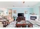 Bright living room featuring a fireplace, flat-screen TV, tile flooring, and elegant furnishings at 6868 Sw 95Th Cir, Ocala, FL 34481