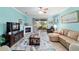 Spacious living room with a fireplace, ceiling fan, tile floors, and a sliding glass door to the patio at 6868 Sw 95Th Cir, Ocala, FL 34481