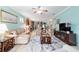 Open-concept living room features a cozy seating area, media center, and views into the kitchen at 6868 Sw 95Th Cir, Ocala, FL 34481