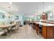 Open-concept living area: dining, living, and kitchen combo with hardwood flooring provides a bright, spacious atmosphere at 6868 Sw 95Th Cir, Ocala, FL 34481