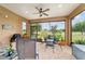 Spacious screened patio with ceiling fan, stylish chairs, and pleasant golf course view at 6868 Sw 95Th Cir, Ocala, FL 34481