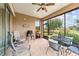 Relaxing screened patio with ceiling fan, comfortable seating, and views of the golf course at 6868 Sw 95Th Cir, Ocala, FL 34481