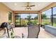 Cozy screened patio area with a ceiling fan and view to a lush backyard and golf course at 6868 Sw 95Th Cir, Ocala, FL 34481