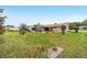 Backyard featuring a screened-in porch, patio, and manicured landscaping, perfect for outdoor enjoyment at 8140 Sw 109Th Street Rd, Ocala, FL 34481
