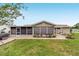 Home exterior featuring a screened-in porch and a cozy patio area, ideal for relaxing outdoors at 8140 Sw 109Th Street Rd, Ocala, FL 34481