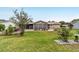 Beautiful backyard view with a screened-in porch, a patio area, and manicured landscaping at 8140 Sw 109Th Street Rd, Ocala, FL 34481