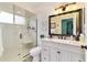 This bright bathroom features a glass shower, white vanity, and neutral accents at 8140 Sw 109Th Street Rd, Ocala, FL 34481