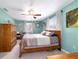 Bedroom with neutral walls, ceiling fan, natural lighting, comfortable bed, and ample storage at 8140 Sw 109Th Street Rd, Ocala, FL 34481